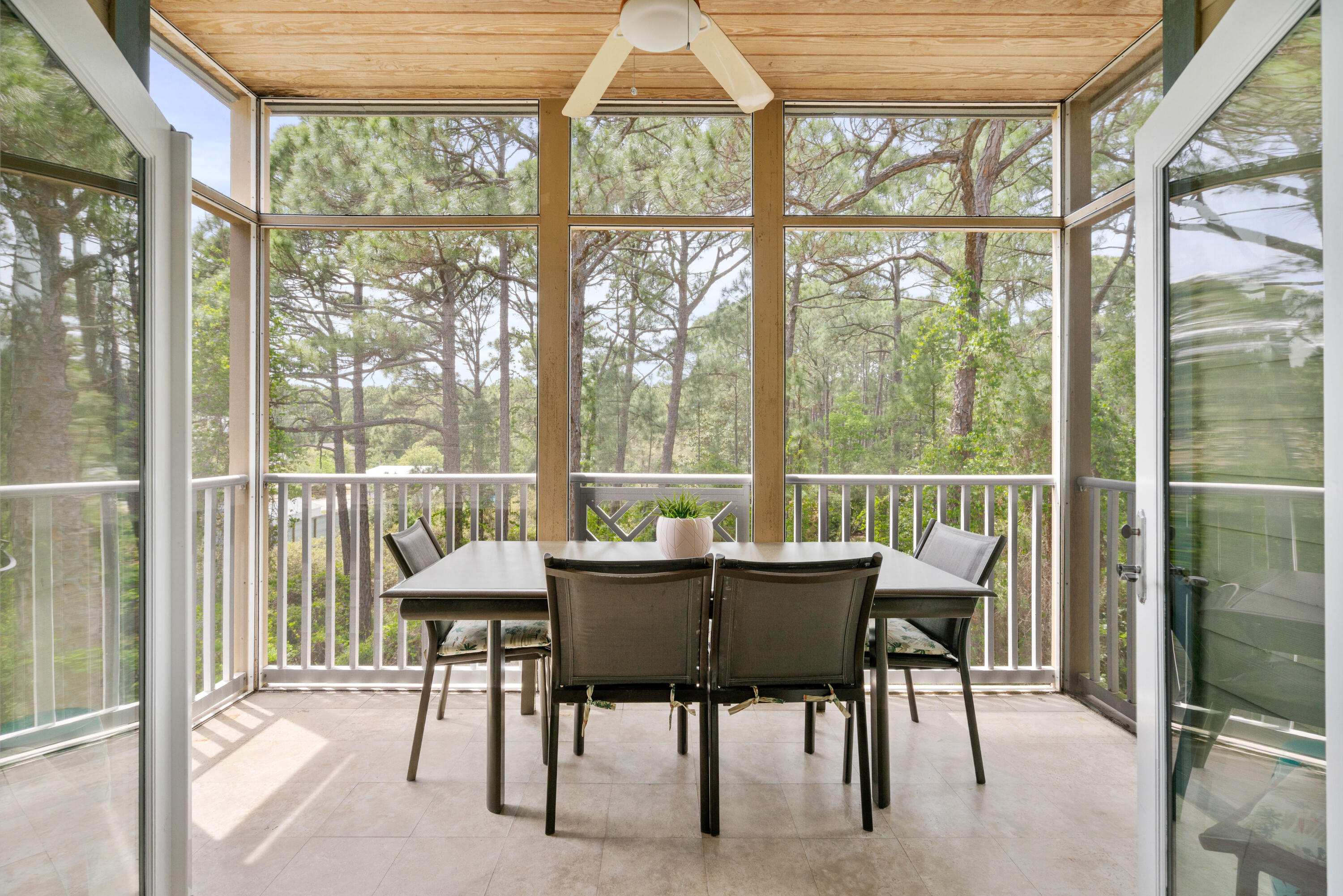 231 Somerset Bridge Road, Unit 2305 Santa Rosa Beach, FL 32459 - Photo 26 of 40 a view of a dining room with furniture large windows and wooden floor