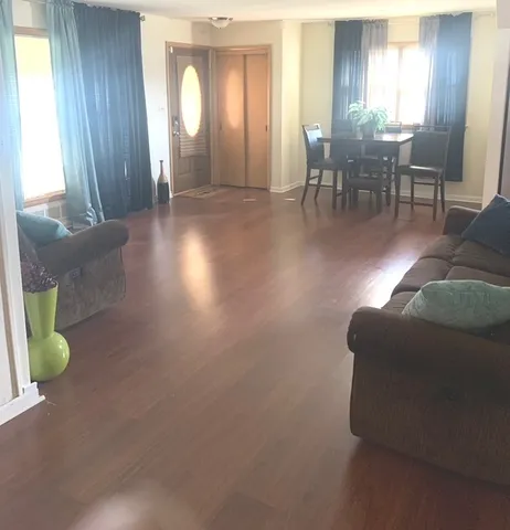 a living room with furniture and a chandelier