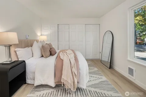 a living room with a bed furniture and a window