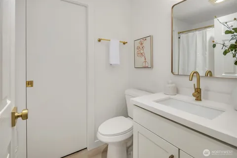 a bathroom with a sink toilet and vanity