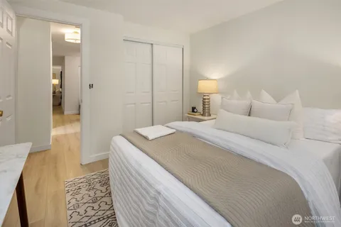 a bedroom with a bed and a lamp