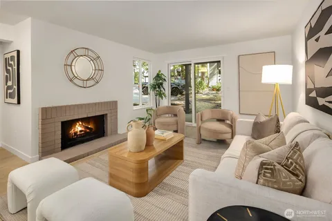 a living room with furniture a fireplace and a large mirror