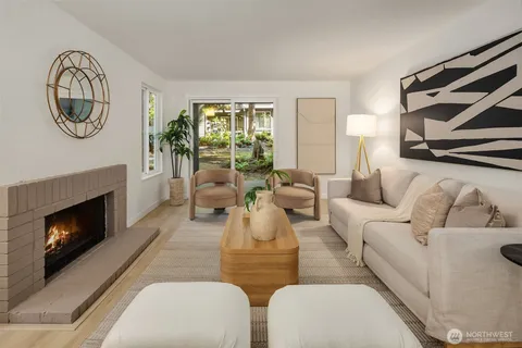 a living room with furniture a window and a fireplace