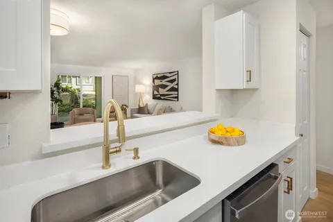 a view kitchen with granite countertop a sink and a stove
