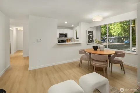 a dining room with furniture and wooden floor