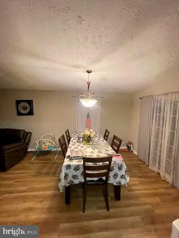 a bed sitting in a room and a mirror