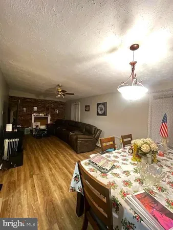 a living room with hard wood flooring and furniture