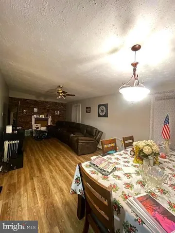 a living room with hard wood flooring and furniture