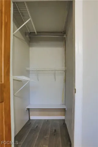 a view of walk in closet with empty racks