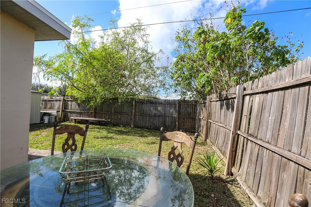 907 Laredo Avenue Lehigh Acres, FL 33936 - Photo 5 of 13 a view of a chairs and table in patio