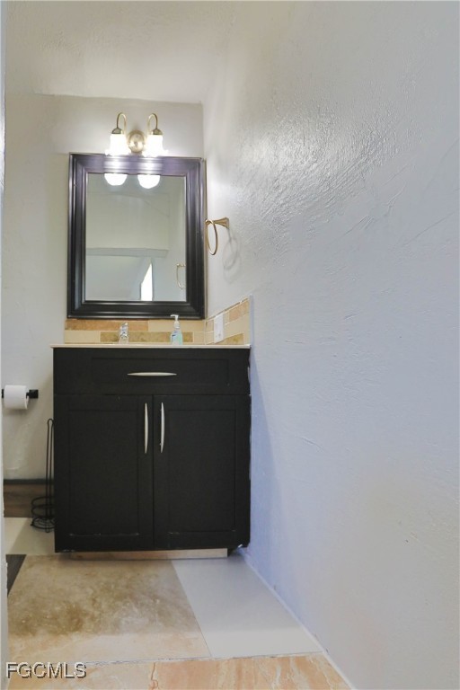 907 Laredo Avenue Lehigh Acres, FL 33936 - Photo 9 of 13 a view of a livingroom with kitchen countertops and wooden floor