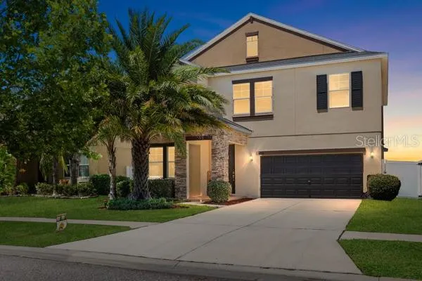 a front view of a house with a yard and garage