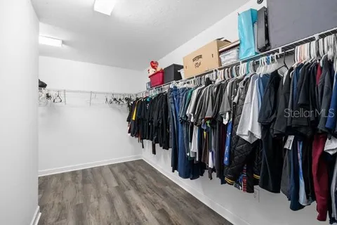 a bed sitting in a spacious bedroom next to a window