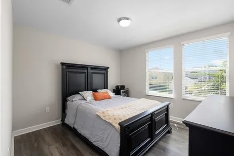 a bathroom with a granite countertop double vanity sink mirror and toilet