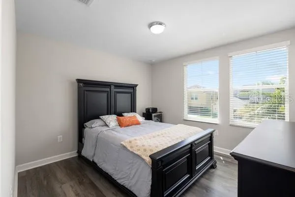 a bathroom with a granite countertop double vanity sink mirror and toilet