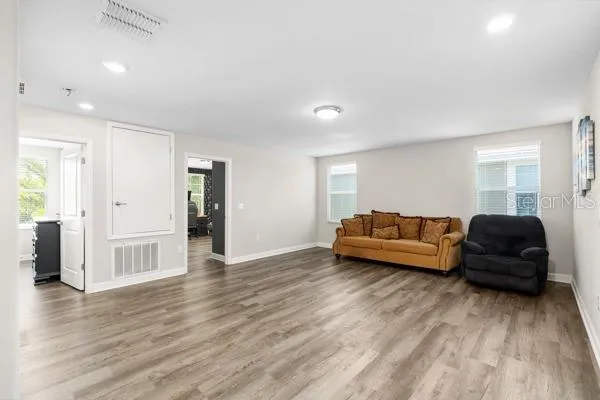 a view of empty room with wooden floor