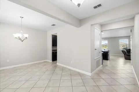 a utility room with granite countertop cabinets and sink