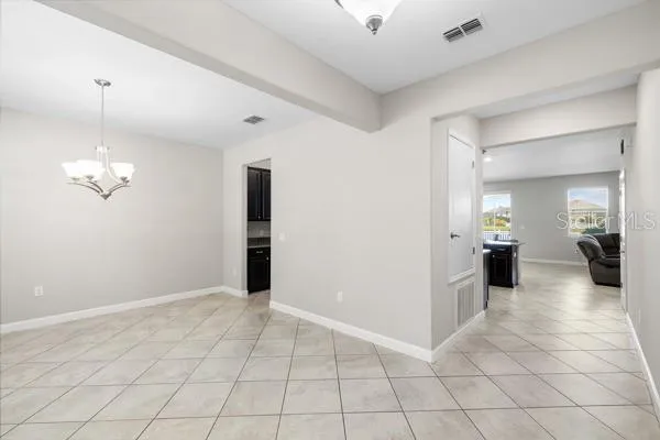 a utility room with granite countertop cabinets and sink