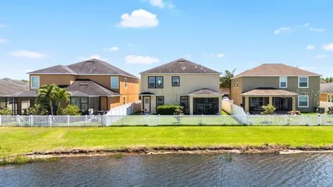 a view of swimming pool of water with lawn chairs and outdoor seating