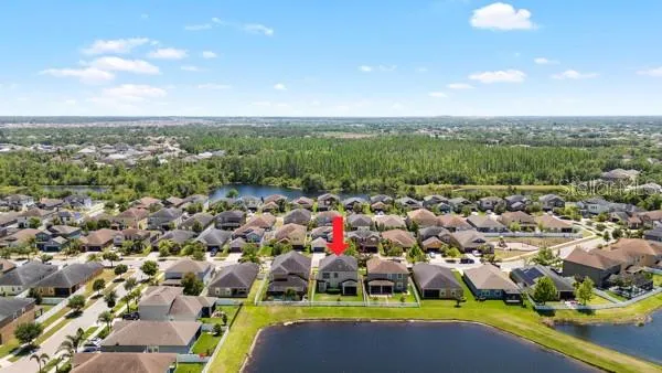 an aerial view of a house with a yard and sitting space