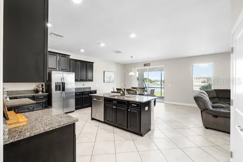 a kitchen with stainless steel appliances granite countertop a sink and a stove