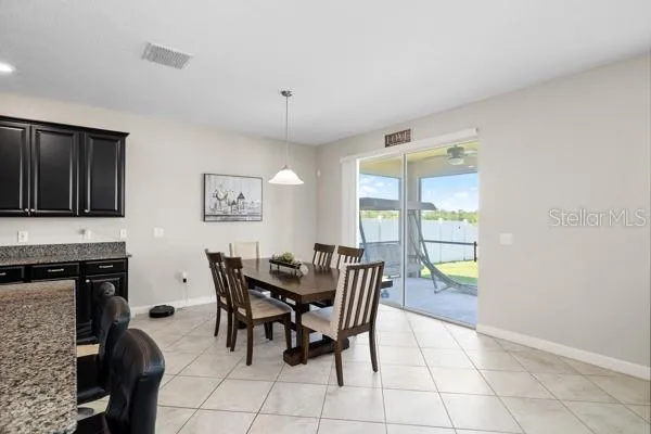 a dining room with furniture and window