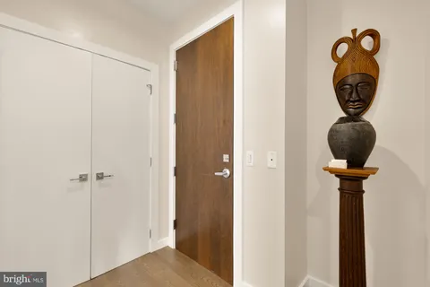 a view of a hallway with wooden door