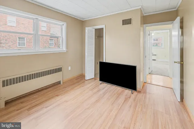 a view of empty room with wooden floor