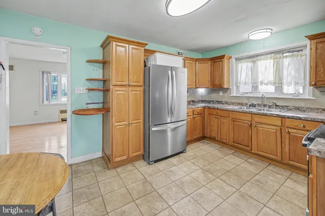 a kitchen with stainless steel appliances granite countertop a refrigerator sink and cabinets