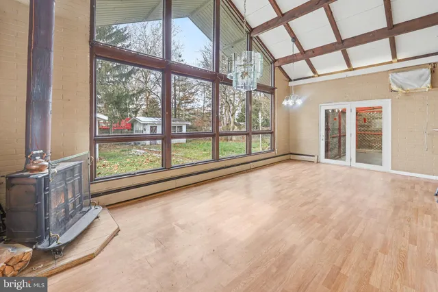 an empty room with large windows