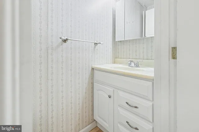 a bathroom with a sink a vanity and a mirror