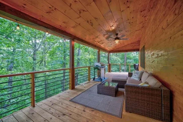 a living room with patio furniture and a floor to ceiling window