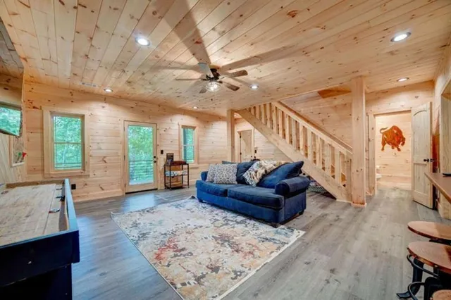 a living room with furniture and wooden floor