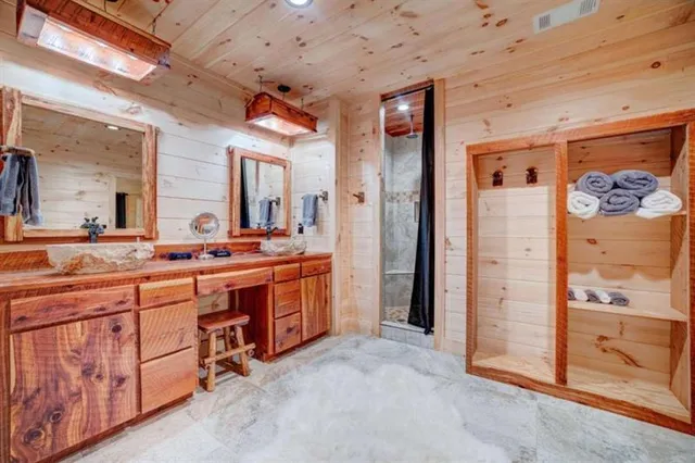 a spacious bathroom with a granite countertop sink mirror and shower