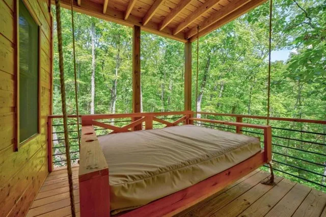 a bed sitting in a bedroom next to a large window