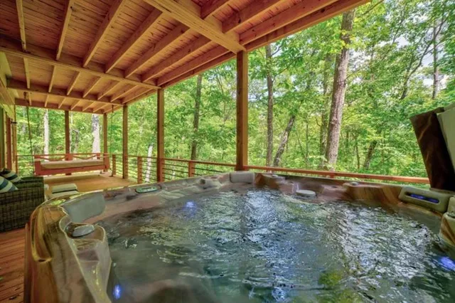 a view of backyard with large trees and outdoor seating