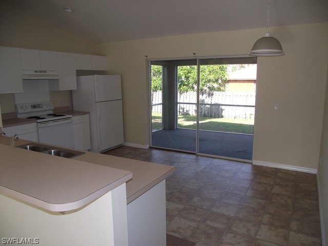 18485 Geranium Road Fort Myers, FL 33967 - Photo 2 of 9 a kitchen with a refrigerator and a stove top oven
