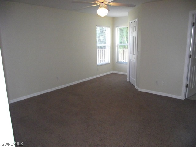 18485 Geranium Road Fort Myers, FL 33967 - Photo 5 of 9 an empty room with windows and fan