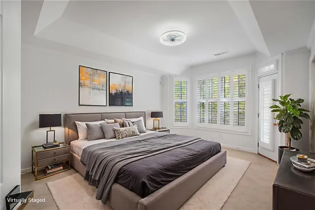 a bedroom with a bed and a potted plant