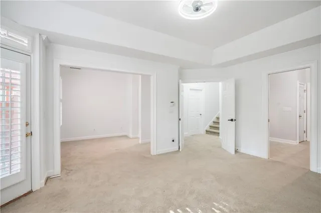 an empty room with windows and closet