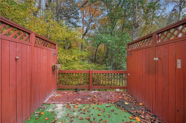 a view of a pathway with a wooden fence