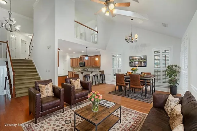 a living room with furniture potted plant and a chandelier