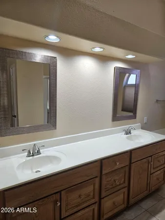 a bathroom with a double vanity sink and a mirror
