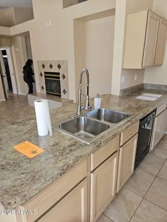 a kitchen with stainless steel appliances granite countertop a sink a stove microwave and refrigerator