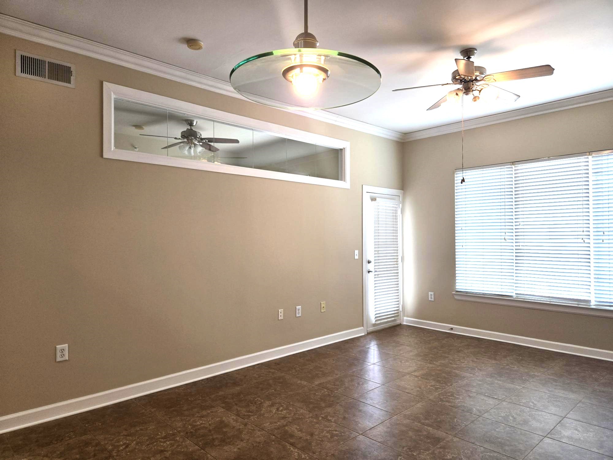 1900 Genesee Street, Unit 207 Houston, TX 77006 - Photo 4 of 50 A view of living room from dining room and balcony door. Notice the window on left that allows natural light to flow to secondary bedroom.
