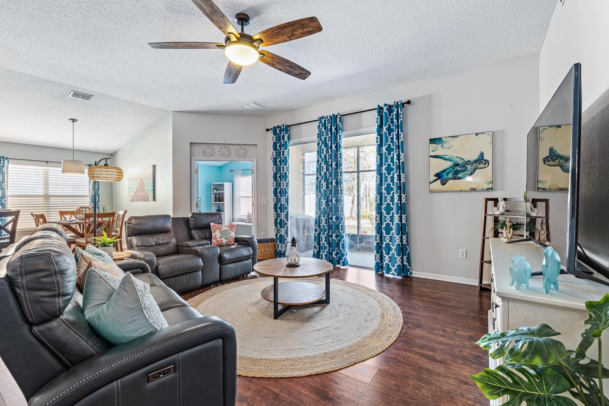 1353 Camp Ridge Lane Middleburg, FL 32068 - Photo 14 of 88 Living area featuring a textured ceiling, dark wood-style floors, a ceiling fan, and healthy amount of natural light