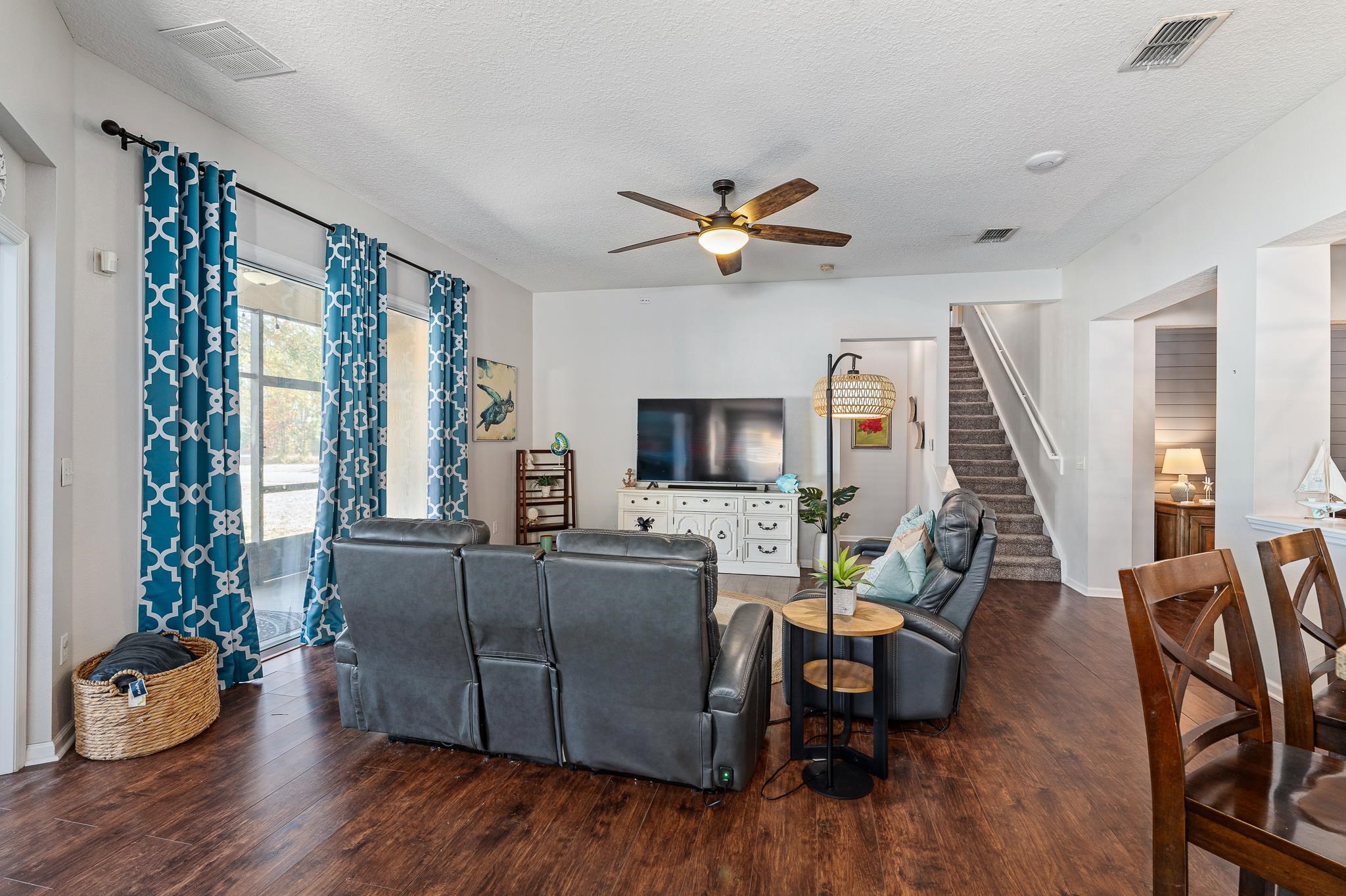 1353 Camp Ridge Lane Middleburg, FL 32068 - Photo 16 of 88 Living area with dark wood-style floors, a ceiling fan, and a textured ceiling