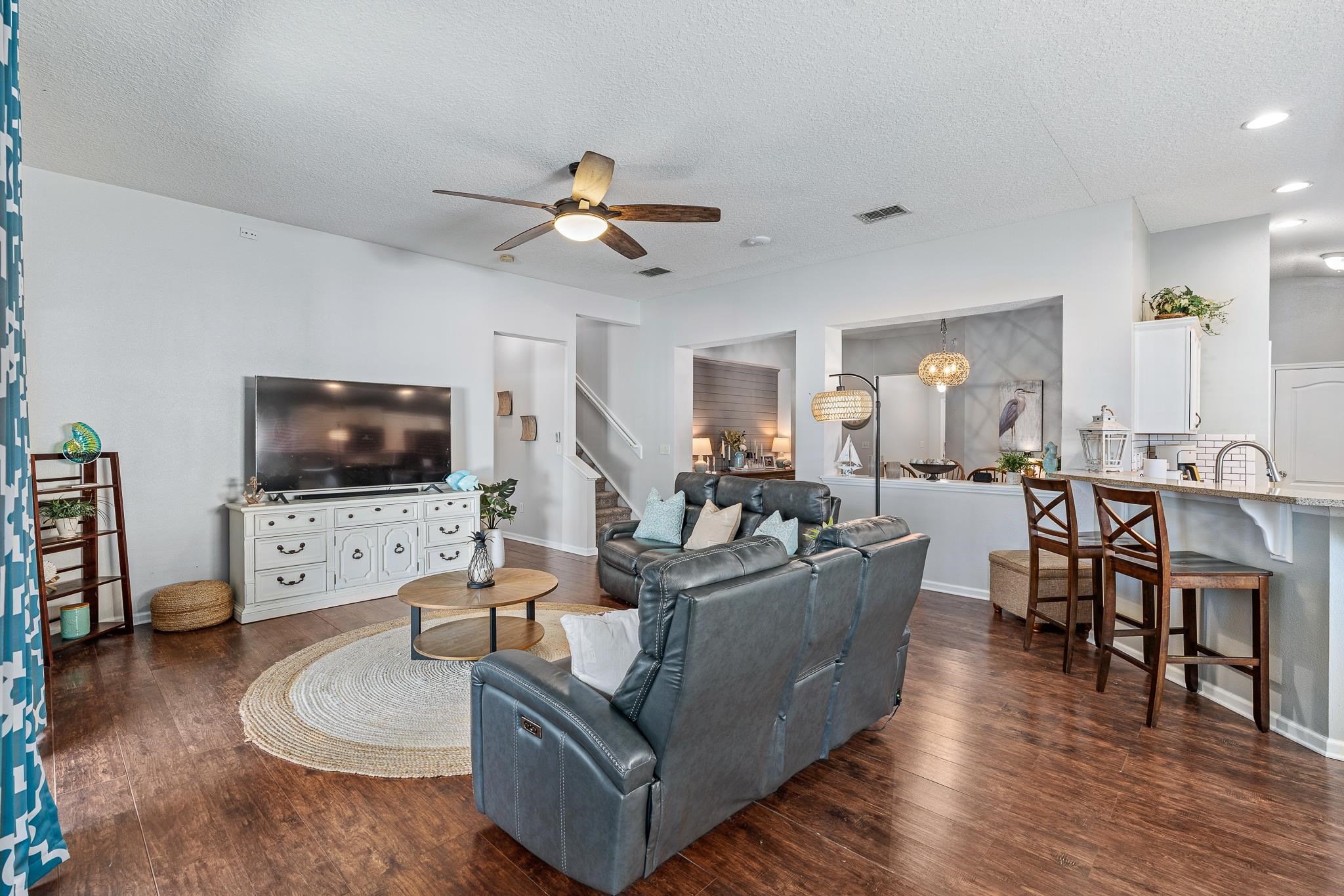 1353 Camp Ridge Lane Middleburg, FL 32068 - Photo 18 of 88 Living area with a textured ceiling, ceiling fan, and dark wood-type flooring
