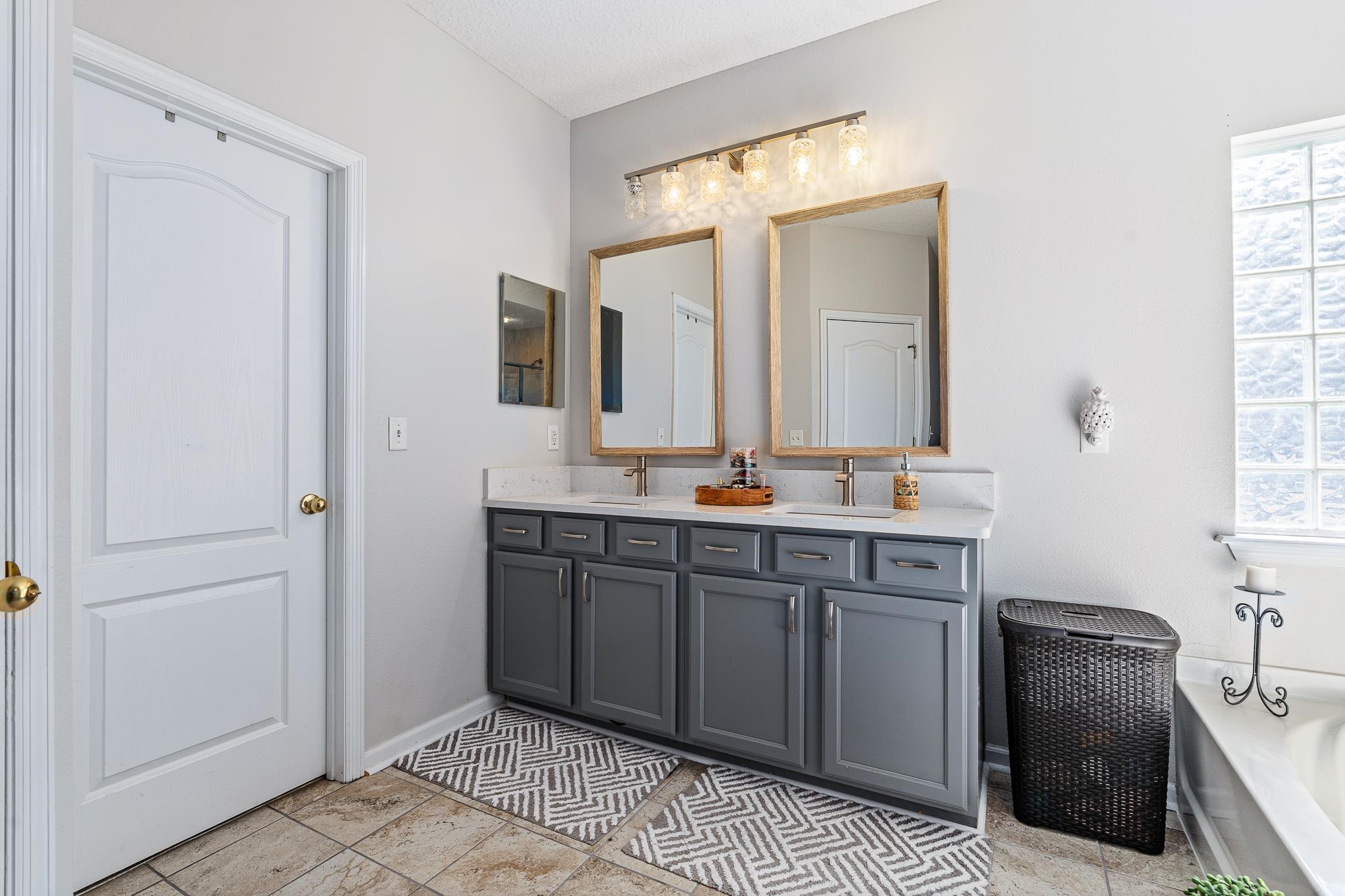 1353 Camp Ridge Lane Middleburg, FL 32068 - Photo 34 of 88 Bathroom featuring double vanity, a bath, and light tile patterned floors