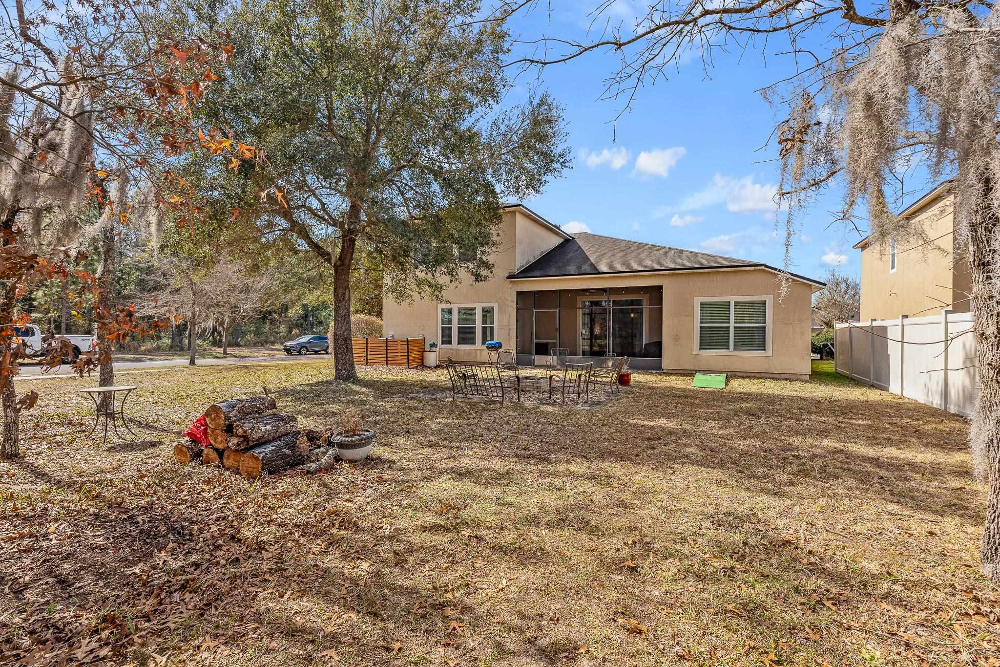 1353 Camp Ridge Lane Middleburg, FL 32068 - Photo 50 of 88 Back of house with stucco siding, a sunroom, and a patio area